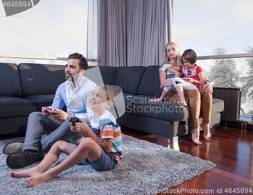 Image of Happy family playing a video game