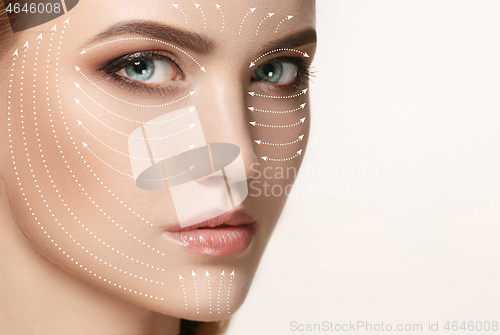 Image of Close-up portrait of young, beautiful and healthy woman with arrows on her face