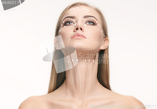 Image of Close-up portrait of young, beautiful and healthy woman with arrows on her face