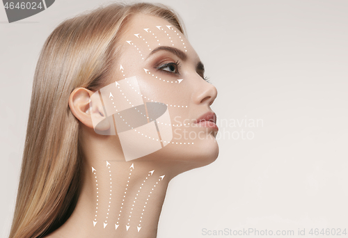 Image of Close-up portrait of young, beautiful and healthy woman with arrows on her face