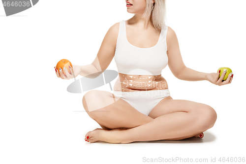 Image of Beauty body care. Woman holding fruits in her hands