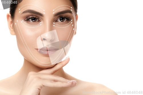 Image of Close-up portrait of young, beautiful and healthy woman with arrows on her face