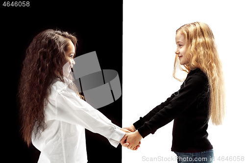 Image of portrait of two happy girls on a white and black background