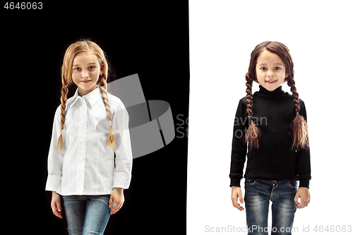 Image of portrait of two happy girls on a white and black background