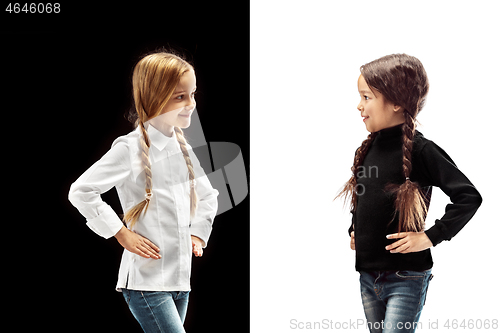 Image of portrait of two happy girls on a white and black background