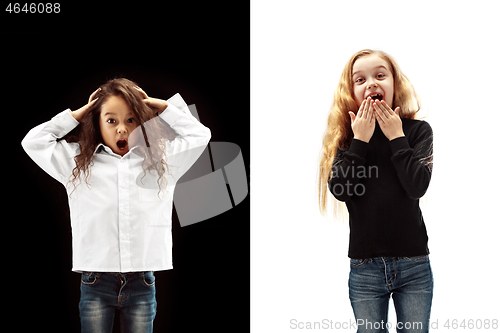 Image of portrait of two happy girls on a white and black background