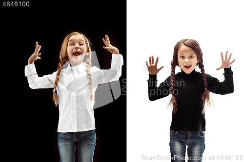 Image of portrait of two happy girls on a white and black background