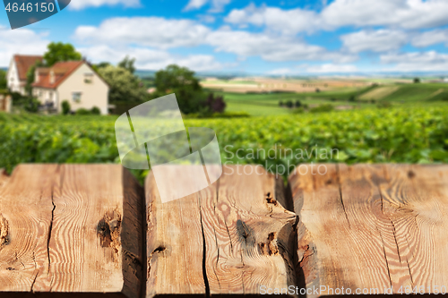 Image of Wooden boards or countertop against blurred countryside landscape on background. Use as mockup for display or montage of your products. Close up