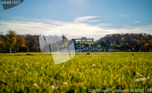 Image of Green field before Schonbrunn Palace in Vienna on a blue sky background.