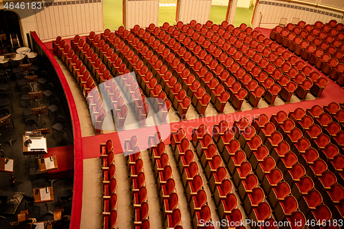 Image of Red seats in the rows without people in Vienna State Opera auditorium.