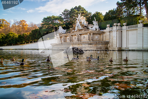 Image of Monument with ancient statues and pond with floating ducks in Vienna.