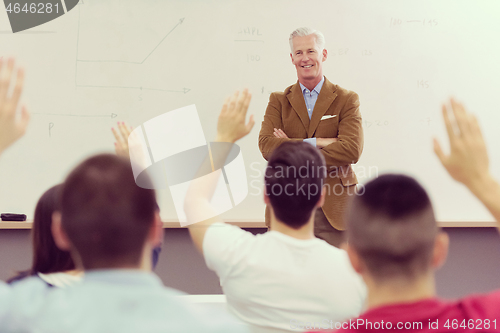 Image of teacher with a group of students in classroom