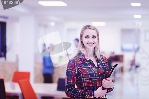 Image of portrait of young business woman at office with team in backgrou