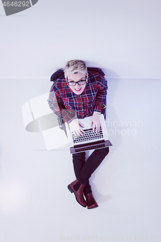 Image of top view of young business woman working on laptop computer