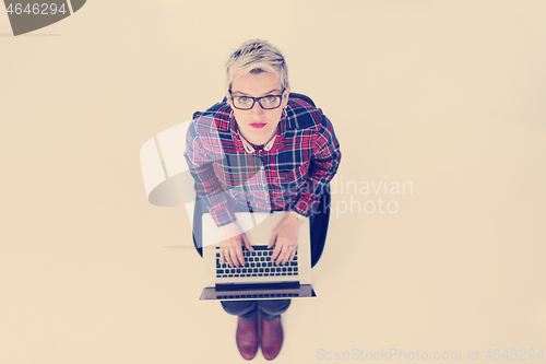 Image of top view of young business woman working on laptop computer