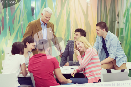 Image of teacher with a group of students in classroom