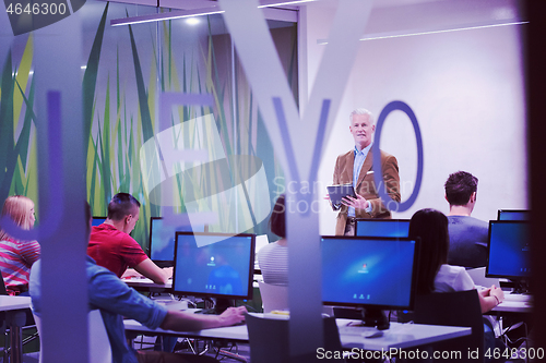 Image of teacher and students in computer lab classroom