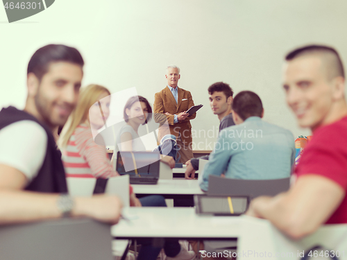 Image of teacher with a group of students in classroom