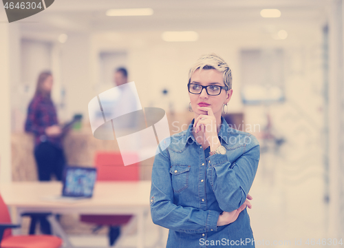 Image of portrait of young business woman at office with team in backgrou