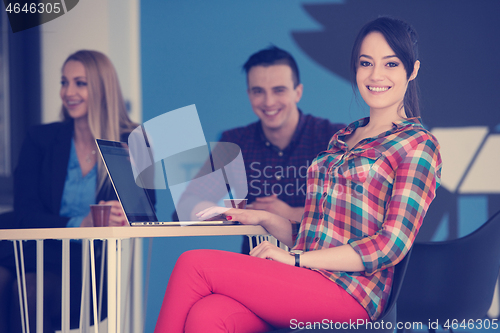 Image of portrait of young business woman at office with team in backgrou