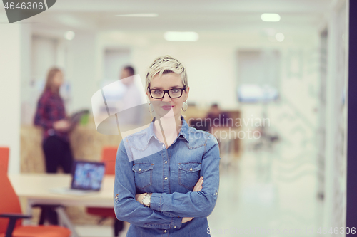 Image of portrait of young business woman at office with team in backgrou