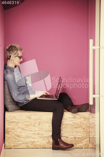 Image of woman in crative box working on laptop