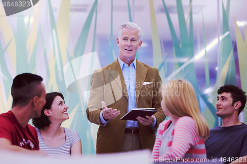 Image of teacher with a group of students in classroom