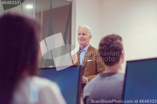 Image of teacher and students in computer lab classroom