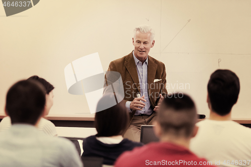 Image of teacher with a group of students in classroom