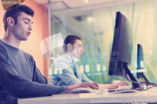 Image of technology students group working  in computer lab school  class