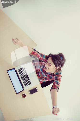 Image of top view of young business woman working on laptop