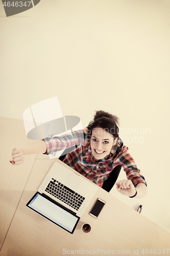 Image of top view of young business woman working on laptop