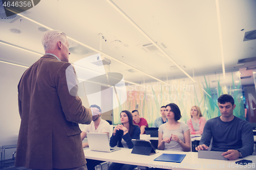 Image of teacher with a group of students in classroom