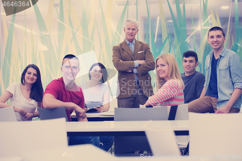 Image of portrait of  teacher with students group in background