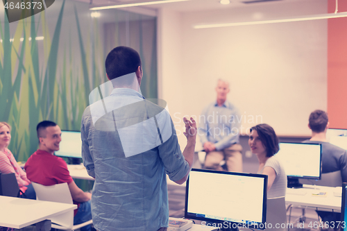 Image of student answering a question in classroom