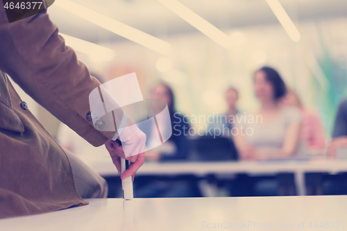 Image of close up of teacher hand while teaching in classroom