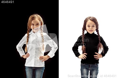 Image of portrait of two happy girls on a white and black background