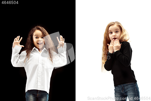 Image of portrait of two happy girls on a white and black background