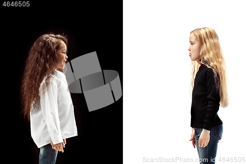 Image of portrait of two happy girls on a white and black background