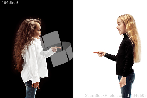 Image of portrait of two happy girls on a white and black background