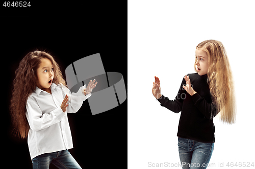 Image of portrait of two happy girls on a white and black background