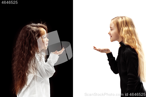 Image of portrait of two happy girls on a white and black background