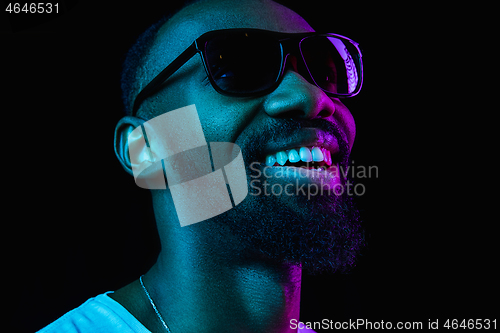 Image of Close up portrait of a young african man indoors