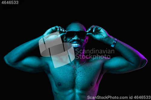 Image of Close up portrait of a young naked african man indoors