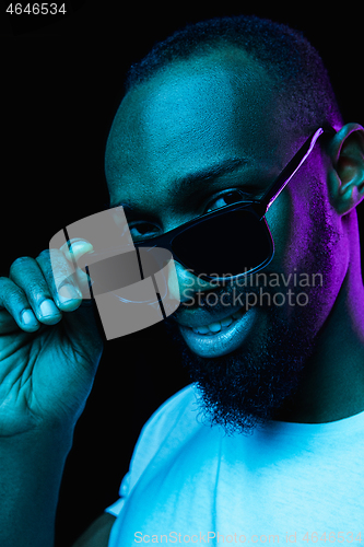 Image of Close up portrait of a young african man indoors