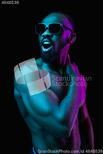 Image of Close up portrait of a young naked african man indoors