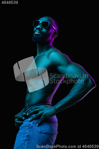 Image of Close up portrait of a young naked african man indoors