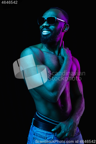 Image of Close up portrait of a young naked african man indoors