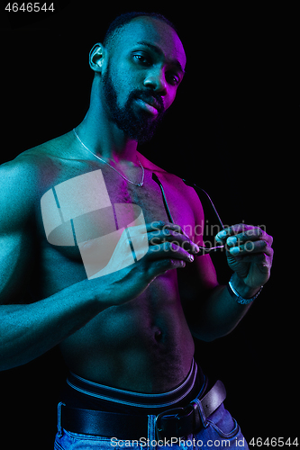 Image of Close up portrait of a young naked african man indoors