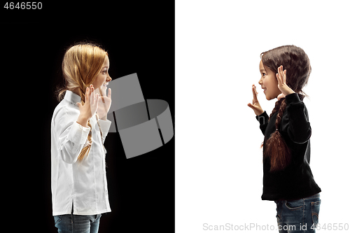 Image of portrait of two happy girls on a white and black background